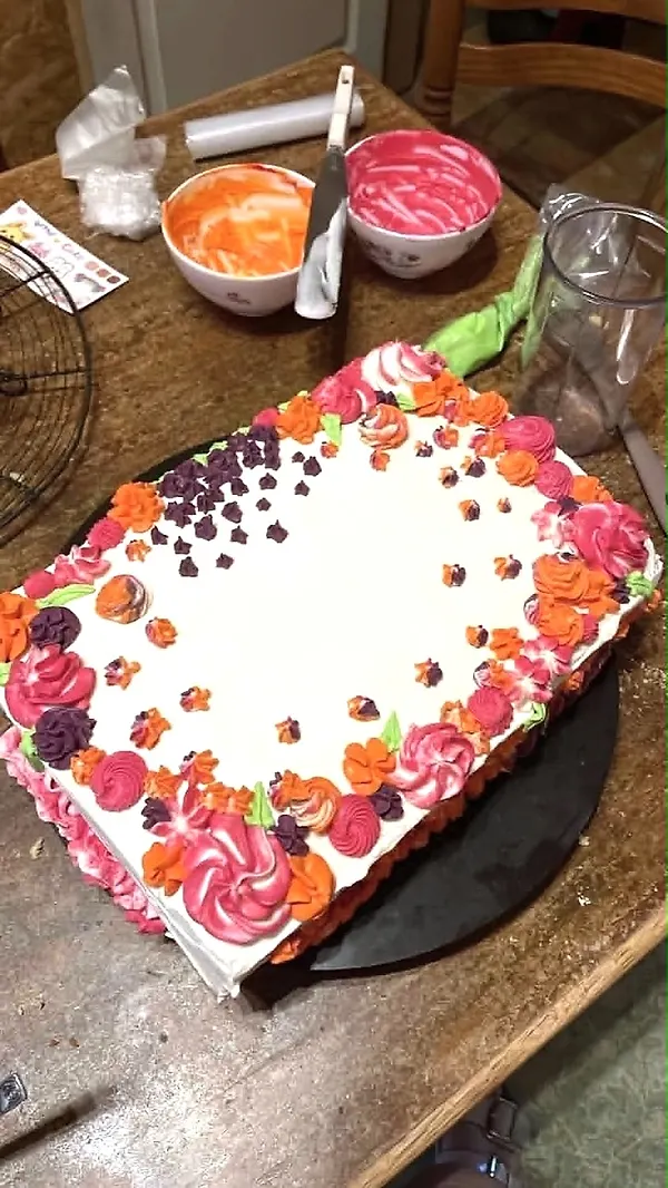 Gâteau rectangulaire couvert de fleurs en crème au beurre colorées